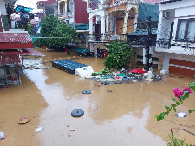 Nước ngập gần hết ôtô tải trên đường Yết Kiêu (TP Yên Bái cũ). Ảnh: Yên Bái