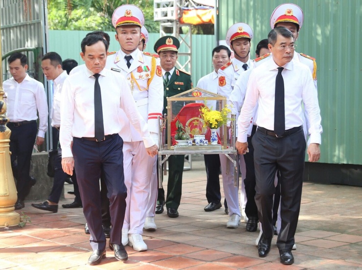 Thủ tướng Lê Minh Hưng cùng Bí thư Thành ủy Trần Lưu Quang di quan hài cốt liệt sĩ được tìm thấy tại công viên Lê Thị Riêng về khu nhà truyền thống. Ảnh: Đình Văn
