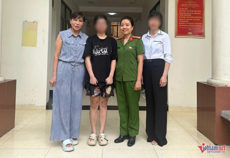 Gia đình nữ sinh chụp ảnh cùng cán bộ Công an phường Hà Đông. Ảnh: D.T.