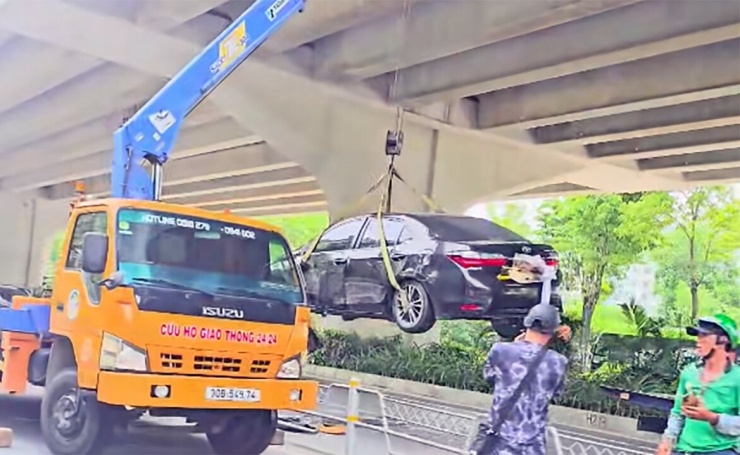 Lực lượng chức năng cẩu xe khỏi hiện trường (Ảnh: Lê Hoàng Sơn)