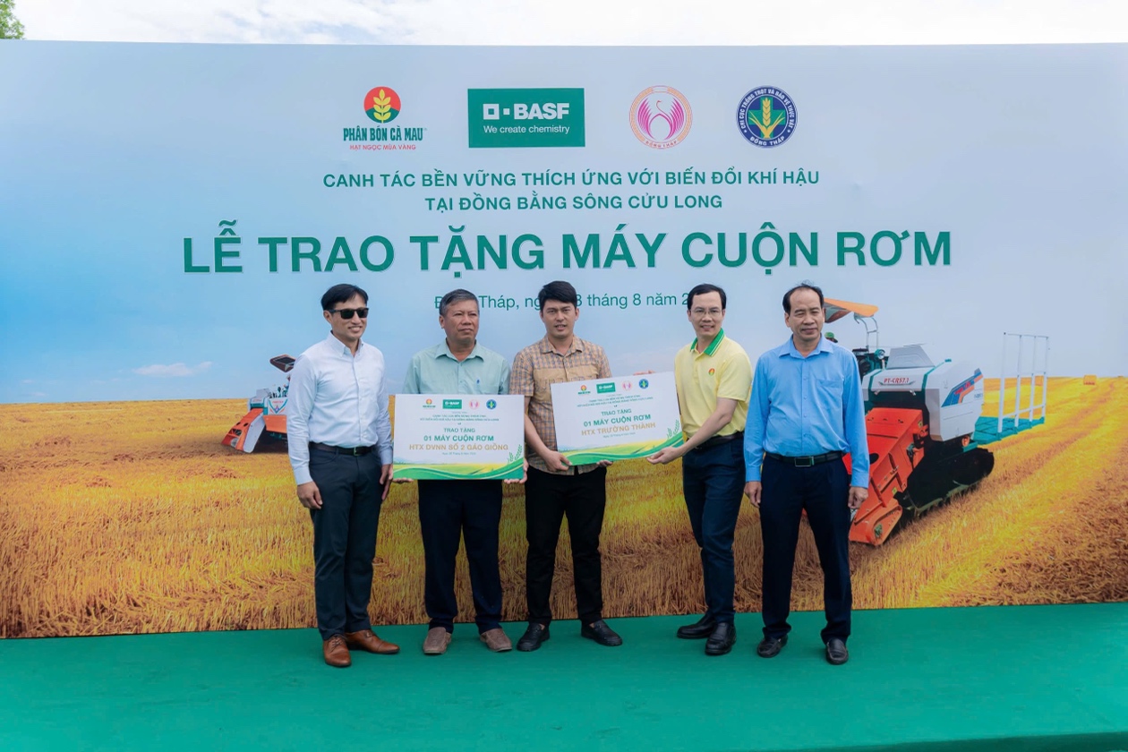 Đại diện các HTX nhận máy cuộn rơm từ chương trình