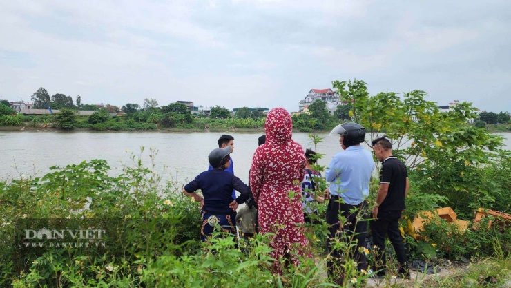 Người dân đứng trên bờ sông dõi theo lực lượng chức năng tìm kiếm. Ảnh: Nguyễn Hoà