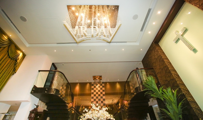 Điểm nổi bật nhất trong phòng khách khẳng định đây là căn nhà của Đàm Vĩnh Hưng là những chùm đèn lớn kết thành chữ &#34;Mr Đàm&#34;. Ánh sáng màu vàng phù hợp với tổng thể ngôi nhà, tạo ra sự ấm cúng.