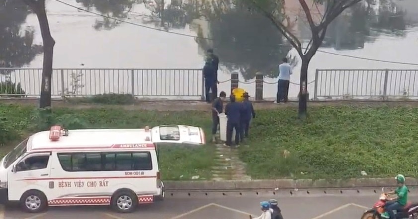 Nhân viên Bệnh viện Chợ Rẫy thả cá phóng sinh xuống kênh Tàu Hủ (ảnh cắt từ clip)