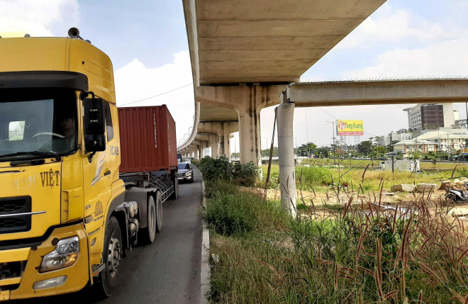 Quan sát bằng mắt thường, độ cao của dầm cầu tương đương với xe chở container lưu thông qua