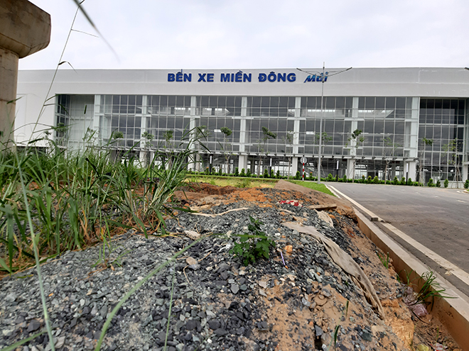 Khu vực lối vào nhà ga chính của bến xe nhiều ụ đất với cỏ dại chưa được san lấp.