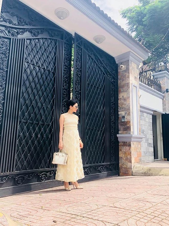 Nữ ca sĩ xách túi hàng hiệu thuộc loại hiếm, tạo dáng trước căn biệt thự bề thế.

