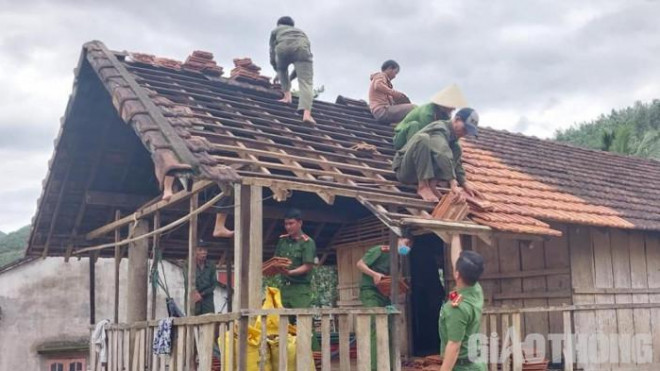 Cán bộ chiến sỹ công an huyện Sơn Hà cùng người dân địa phương dựng lại nhà cho các trường hợp bị bão số 4 làm hư hỏng.