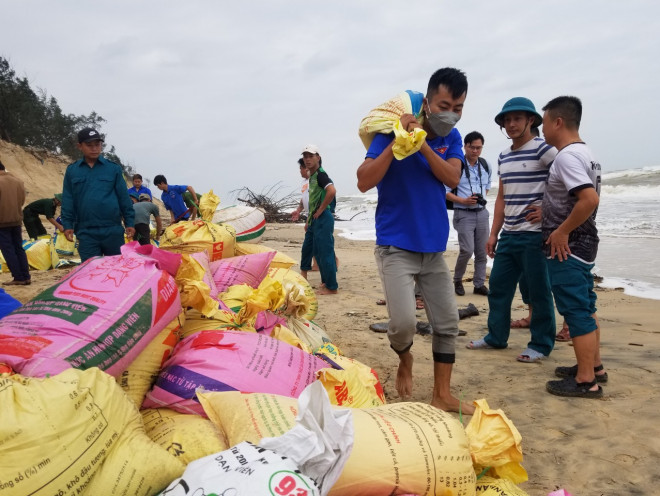 Lực lượng thanh niên được huy động đến để vác cát đắp đê.