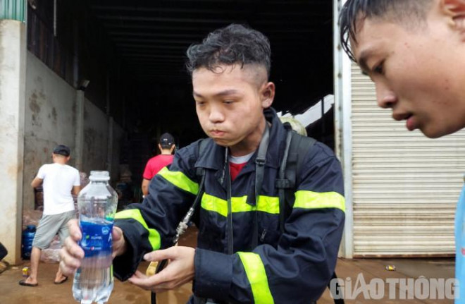 Các chiến sĩ uống nước, lấy sức để tiếp tục chữa cháy. Ảnh: N.H