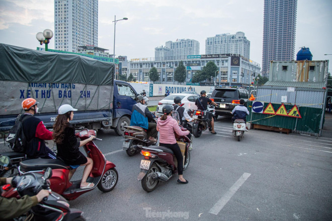 Do bị ''chiếm'' lòng đường, các phương tiện di chuyển chỉ có thể nhích từng bước, xếp hàng chờ đi qua.