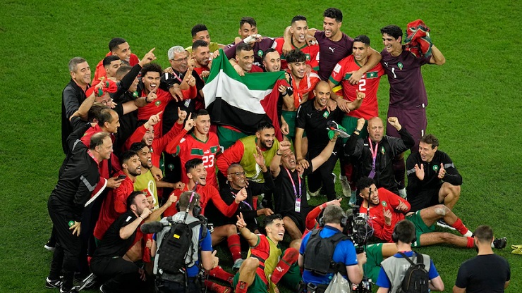 Các cầu thủ Ma Rốc chụp ảnh khi giương cao lá cờ Palestine.