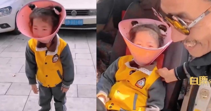 Bé gái trong sự việc đeo chiếc vòng cổ cho chó. Ảnh: SCMP