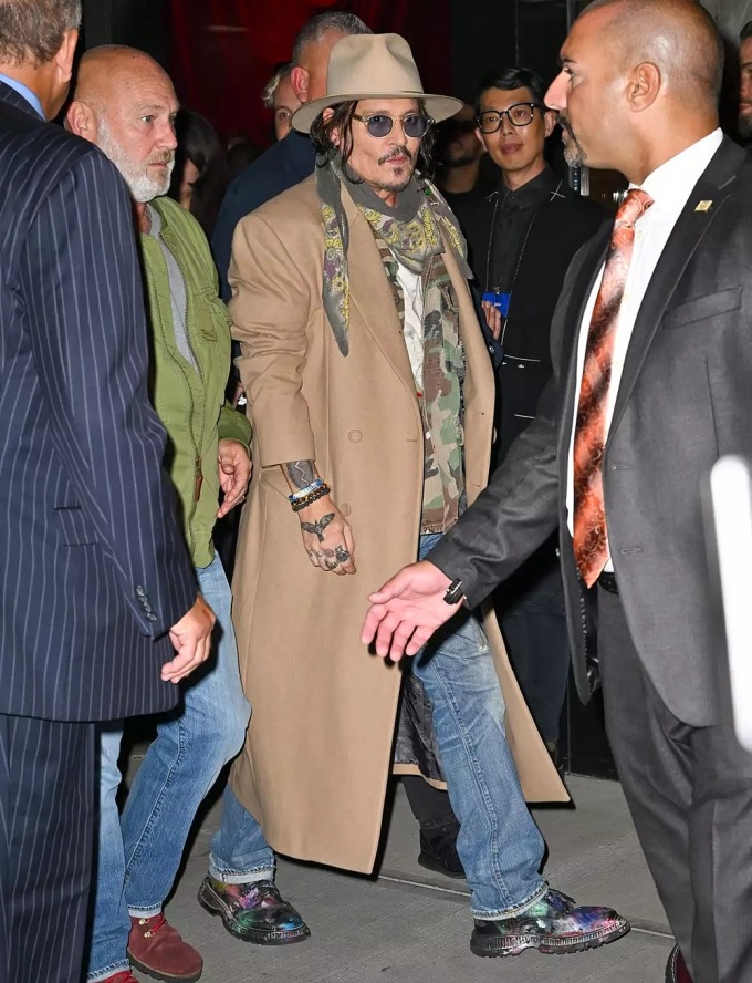 Johnny Depp diện áo khoác dài phối cùng giày họa tiết sơn phun tại buổi quảng bá ngày 30/9. Ảnh: GC Images