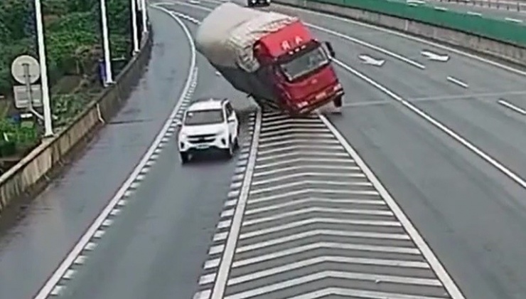 Chiếc xe ô tô con đột ngột chuyển làn khiến xe tải lật nghiêng.