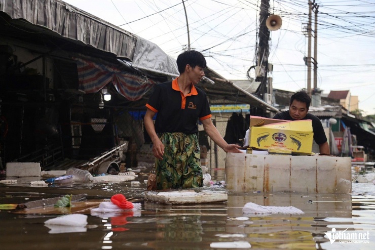 Tiểu thương vớt vát tài sản khi nước ngập các ki-ốt.