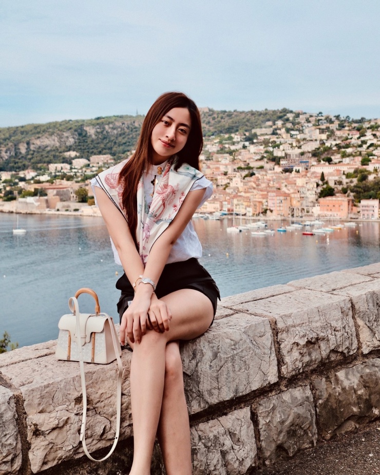 Chiếc túi xách Goyard giá khoảng 130 triệu đồng được Lương Thùy Linh chưng diện liên tục trong chuyến đi. Hoa hậu mặc áo 45 triệu đồng của Louis Vuitton phối khăn lụa họa tiết, tạo dáng ở Nice.