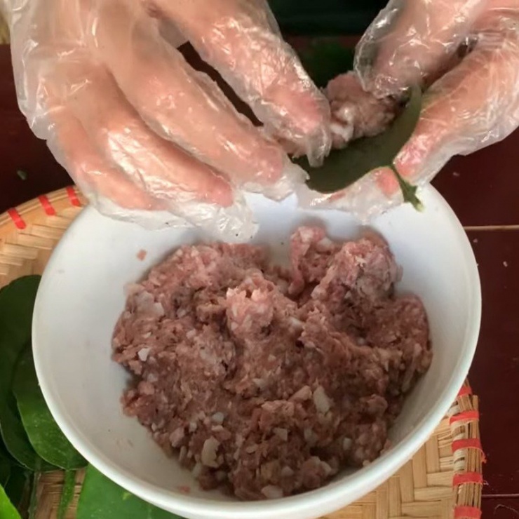 Cho một lượng nhân thịt vừa đủ lên mặt lá bưởi.
