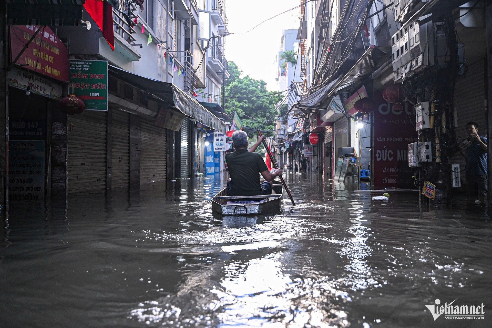 Một vài người dùng thuyền, bè xốp để di chuyển, hỗ trợ chở đồ đạc cho hàng xóm. Ảnh: Huy Nguyễn