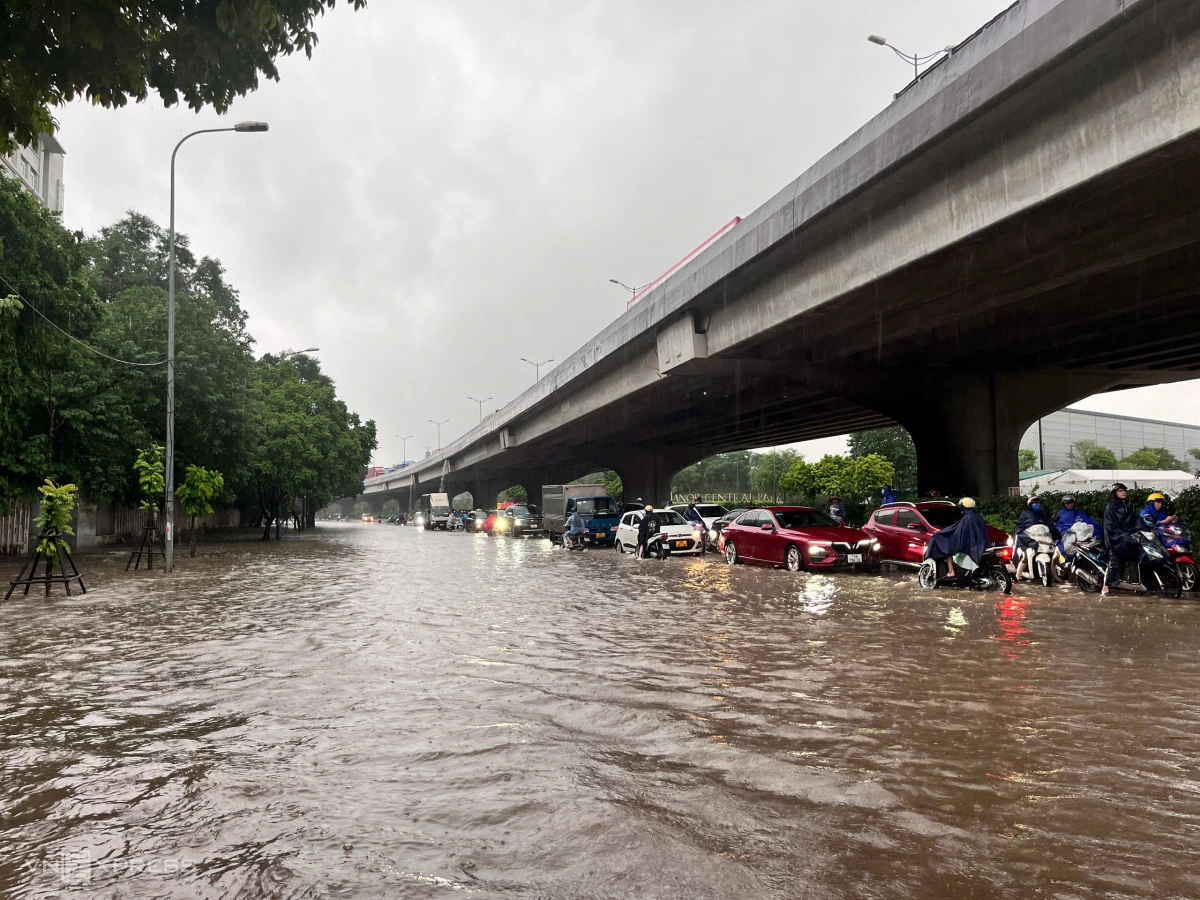Ôtô, xe máy di chuyển chậm qua đường Nguyễn Xiển và gần như đứng yên dưới chân vành đai 3 trên cao do đường ngập sâu. Ảnh: Huy Mạnh