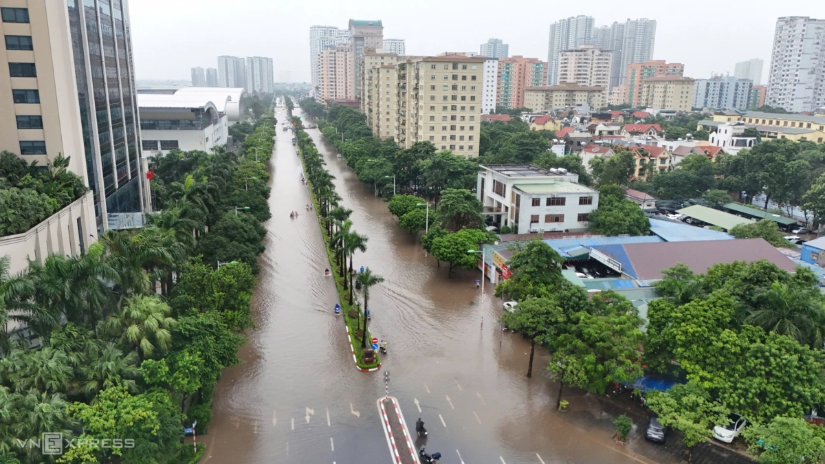 Đường Lê Đức Thọ ngập sâu, một số xe máy liều lĩnh di chuyển qua. Ảnh: Văn Ngọc