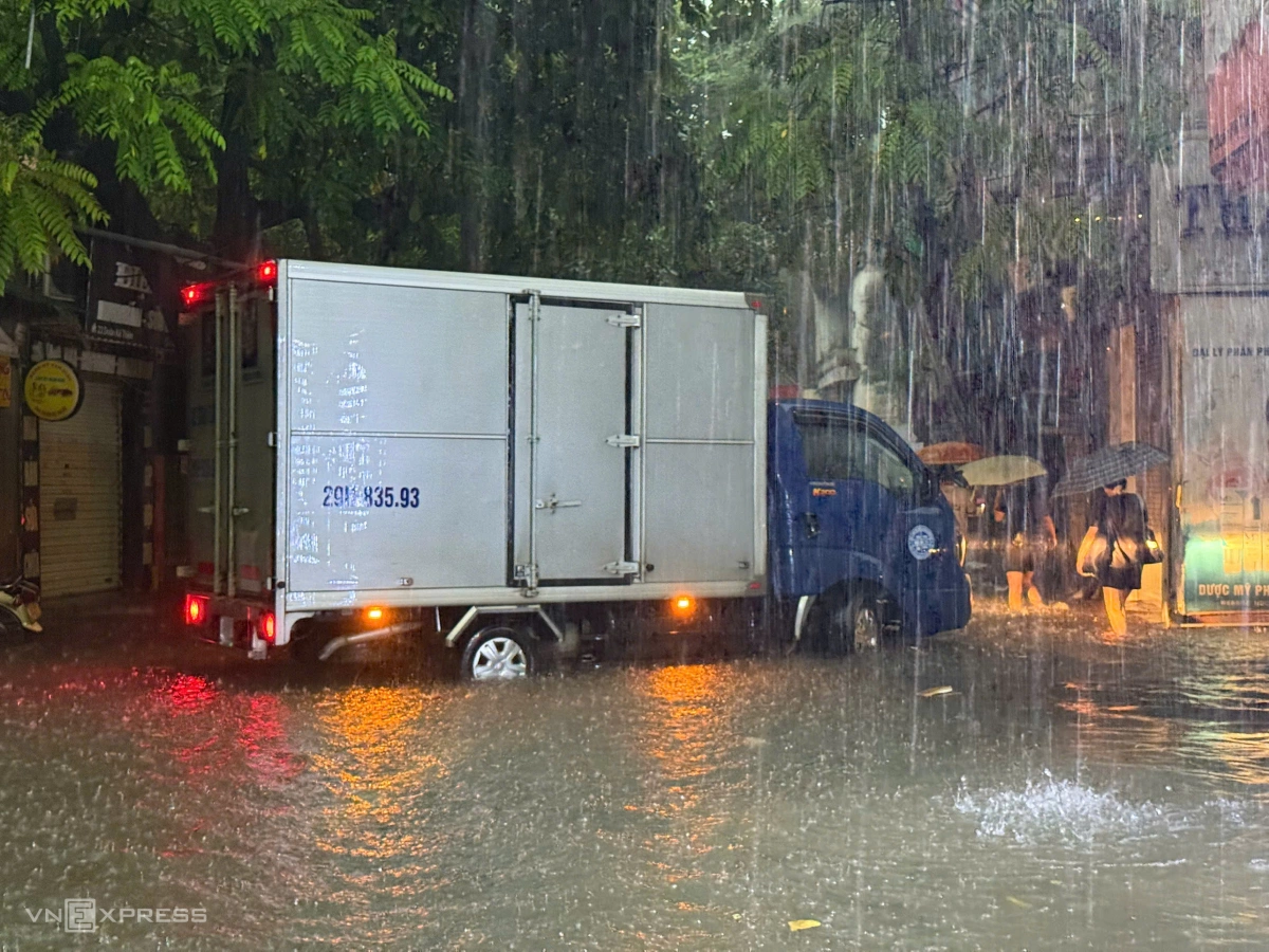 Nước ngập nửa bánh xe tải. Ảnh: Lộc Chung