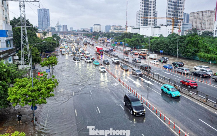 Xe máy ‘rẽ sóng’ giữa phố, tìm đường lên cao tốc tránh ngập tại Hà Nội - 1