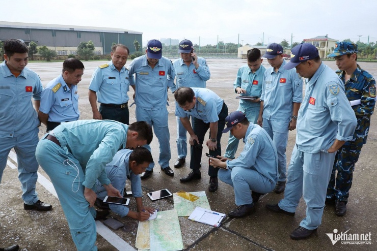 Trước giờ lên đường, tổ công tác họp bàn để thống nhất hành trình, vị trí thả hàng cứu trợ. 