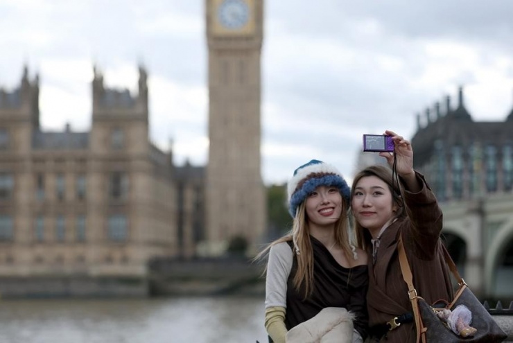 Hai du khách Trung Quốc chụp ảnh tự sướng gần tháp Big Ben ở London, Anh, ngày 5/10/2025.