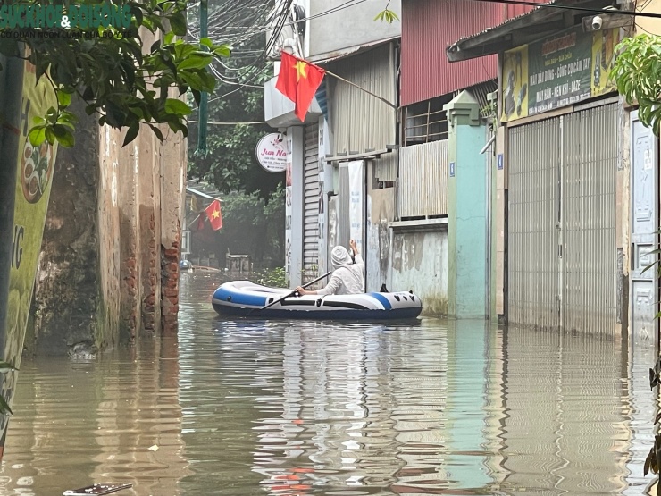 Người dân dùng thuyền phao di chuyển qua lại trên phố.