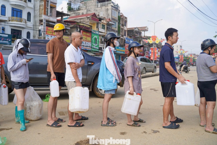 Mỗi người dân đều cầm một can nhựa trên tay, kiên nhẫn xếp hàng chờ tới lượt mua xăng.