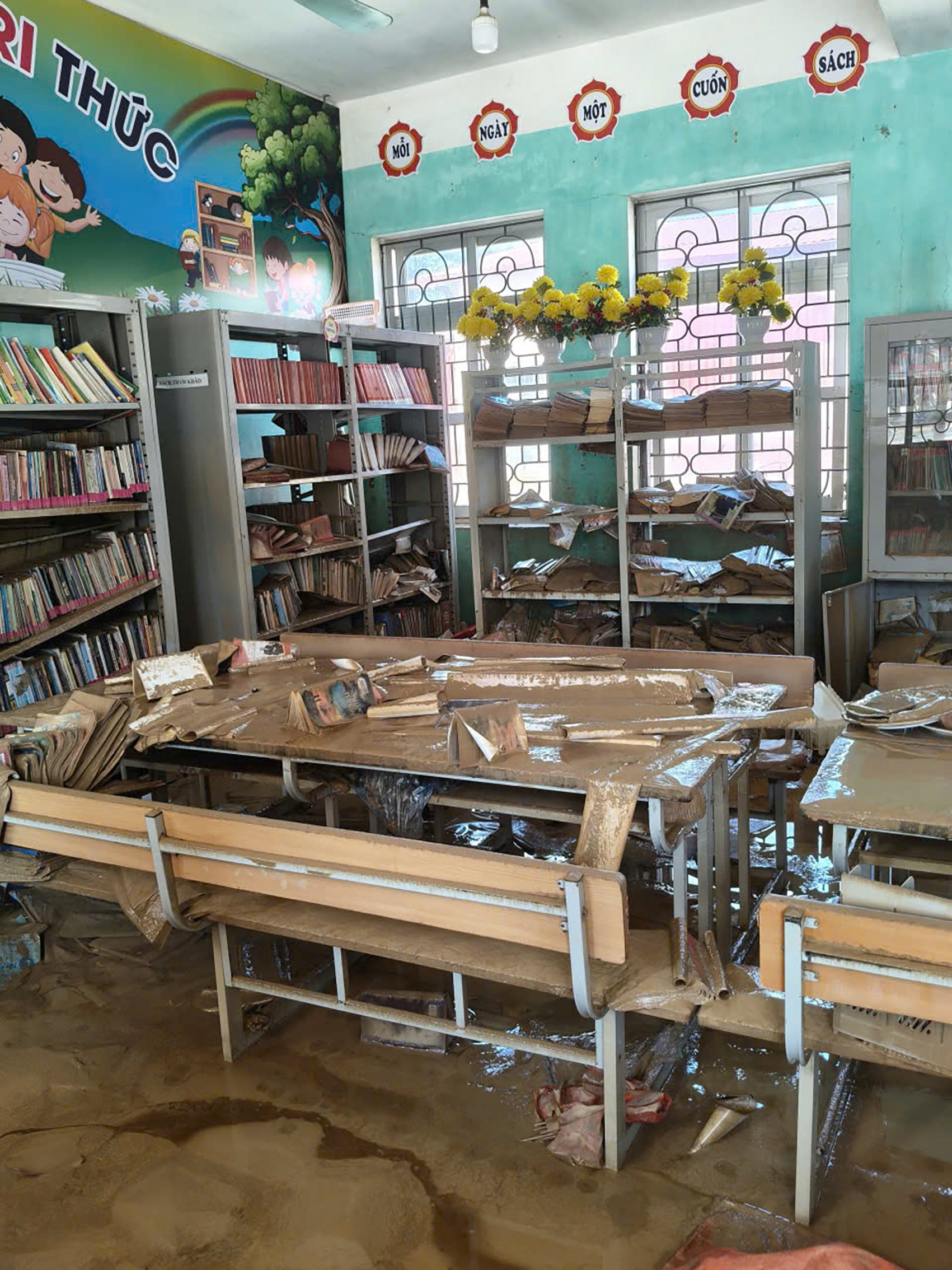 Đồ dùng giảng dạy, bàn ghế hư hỏng hết sau khi bị ngâm nước nhiều ngày. Ảnh: Đ.X