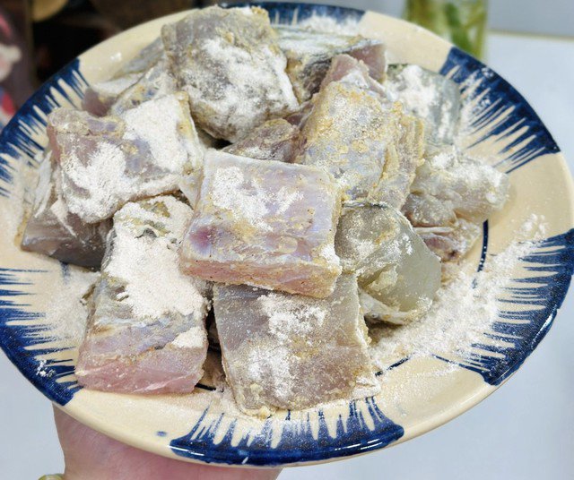 Bước 1 sơ chế cá, đem rửa nhanh cá khô một nắng bằng nước sạch rồi thấm khô. Cắt miếng vừa ăn rồi lăn đều cá qua lớp bột chiên giòn khô, phủ kín để khi chiên cá giòn hơn. Ảnh: Thanh Huệ