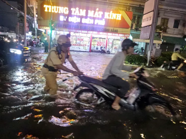 Giao lộ Huỳnh Tấn Phát - Phú Thuận ngập rất sâu, CSGT trạm Đa Phước điều tiết giao thông và hỗ trợ người dân.