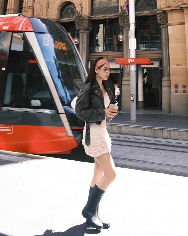 Mỹ nhân Hà thành diện đầm ngắn cùng áo khoác lửng phong cách Chic Streetwear khi dạo phố Australia. Những món phụ kiện như băng đô trùm đầu, boots cao su giúp bộ cánh của cô thêm 'chất'.