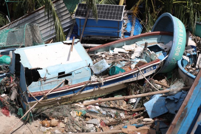Ghe đánh cá vỏ composite bị sóng đánh từ đìa văng lên bờ hư hỏng. Ảnh: Đình Văn
