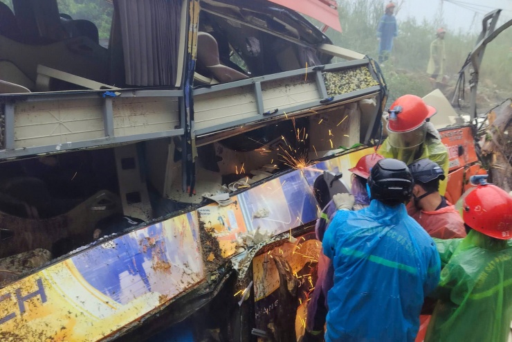 Lực lượng chức năng dùng máy cắt khung thép xe khách để tìm thi thể nạn nhân. Ảnh: N.X
