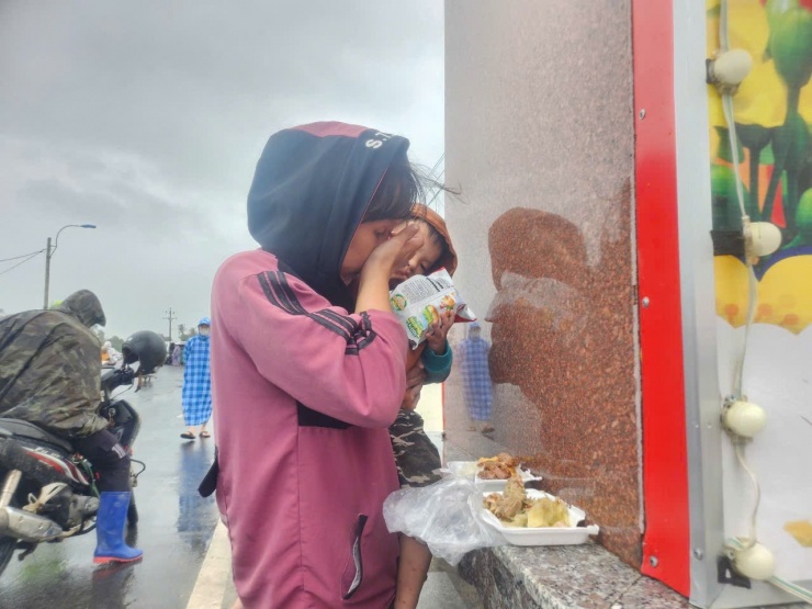 Chị Phan Thị Tiểu Nhi (áo hồng) bật khóc khi ăn suất cơm đầy đủ sau bão.