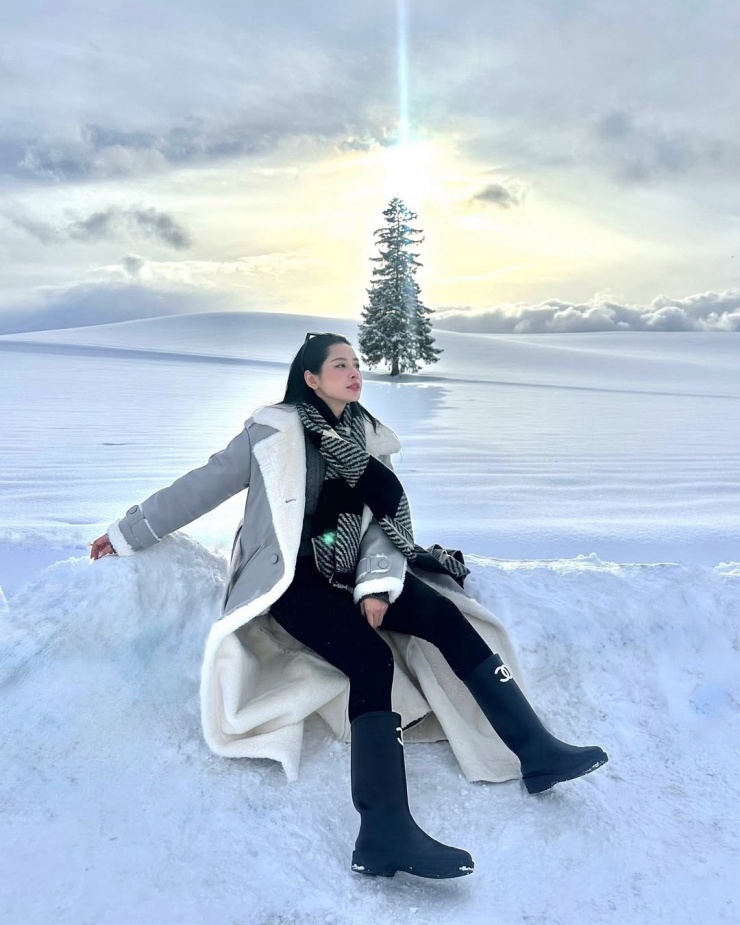 Trong chuyến đi chơi ở Nhật, Chi Pu chọn áo khoác dáng dài lót lông cừu, phối quần legging giữ nhiệt và bốt Chanel.