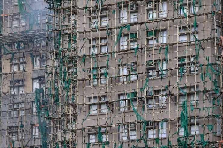 Giàn giáo tre phủ lưới xanh bên ngoài một tòa nhà ở Wang Fuk Court. (Ảnh: Reuters)