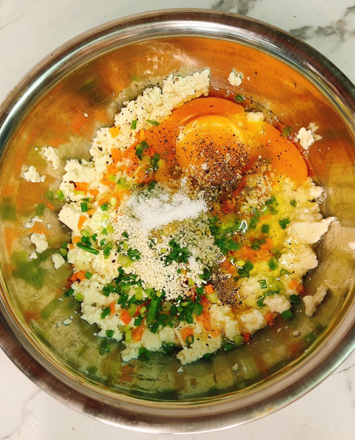 Trộn đều cùng cà rốt xắt nhỏ, hành lá, trứng và các loại gia vị.