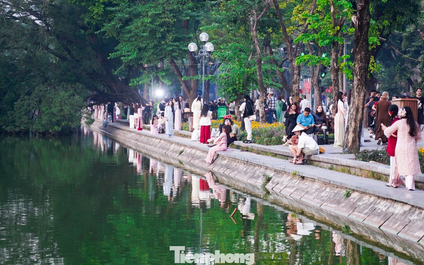 Dọc theo bờ hồ, hàng trăm bạn trẻ xúng xính trong những bộ áo dài đa dạng kiểu dáng, màu sắc và họa tiết. Hoa tươi, quạt lụa… trở thành những phụ kiện quen thuộc được mang theo để tô điểm cho bộ ảnh.
