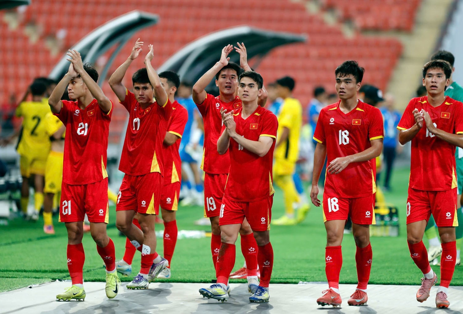 Các cầu thủ U22 Việt Nam tri ân cổ động viên sau trận với những gương mặt tươi vui.