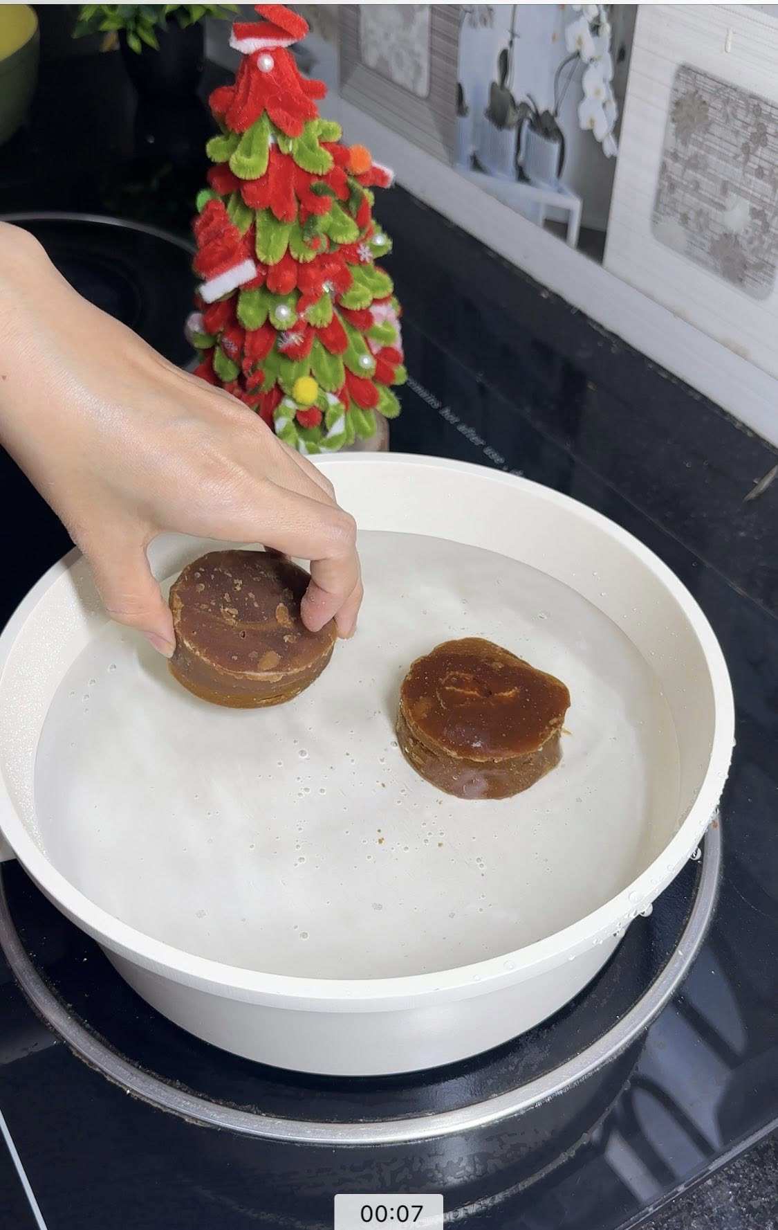 Đun sôi 1,5 lít nước cùng 2 viên đường thốt nốt.