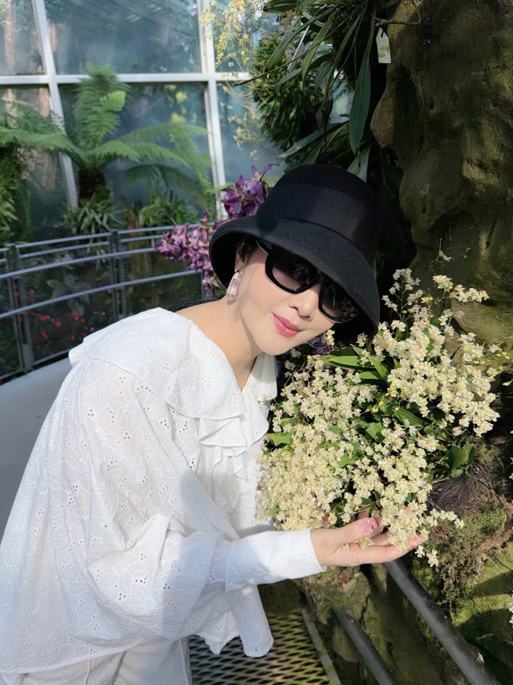 Hoa hậu Giáng My tạo dáng bên hoa.&nbsp;