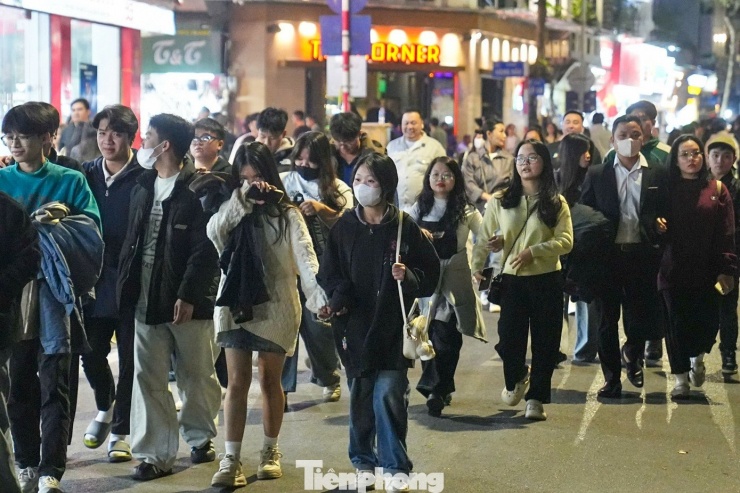 Tối nay thời tiết thuận lợi, ấm áp nên nhiều người dân, du khách chọn phố đi bộ Hồ Hoàn Kiếm để đón năm mới.